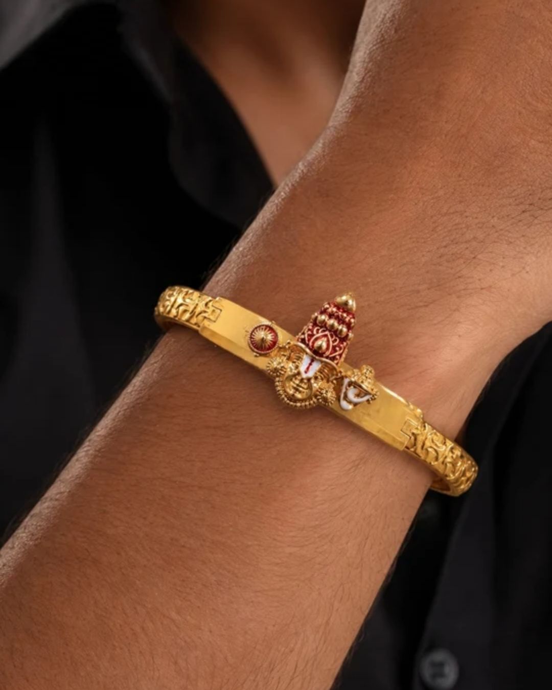 AClose-Up of a South Indian man styling a gold plated Balaji design bracelet with traditional and ethnic outfits. The bracelet features temple-inspired craftsmanship, embossed detailing and an adjustable secure clasp that adds a bold and devotional touch to festive and everyday styling.