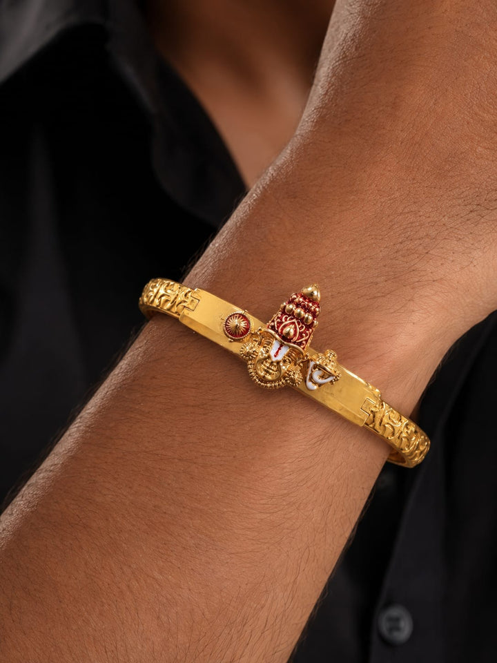 AClose-Up of a South Indian man styling a gold plated Balaji design bracelet with traditional and ethnic outfits. The bracelet features temple-inspired craftsmanship, embossed detailing and an adjustable secure clasp that adds a bold and devotional touch to festive and everyday styling.