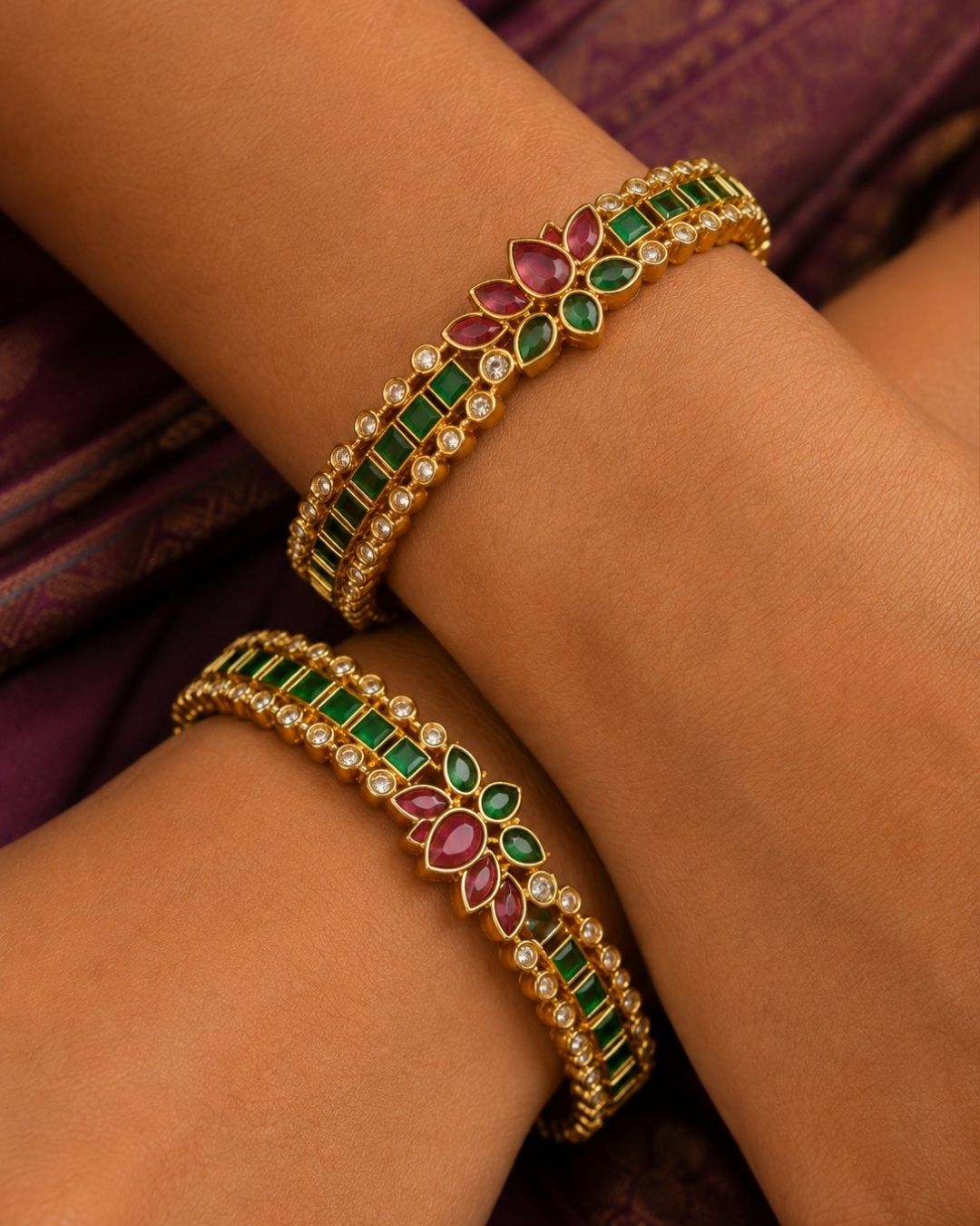 Designer emerald floral bangles with brilliant zircon stones and vibrant ruby-inspired floral motifs.
Expertly crafted with premium gold plating for a luxurious traditional appearance.
Perfect for weddings, festivals, ethnic wear, and gifting.
