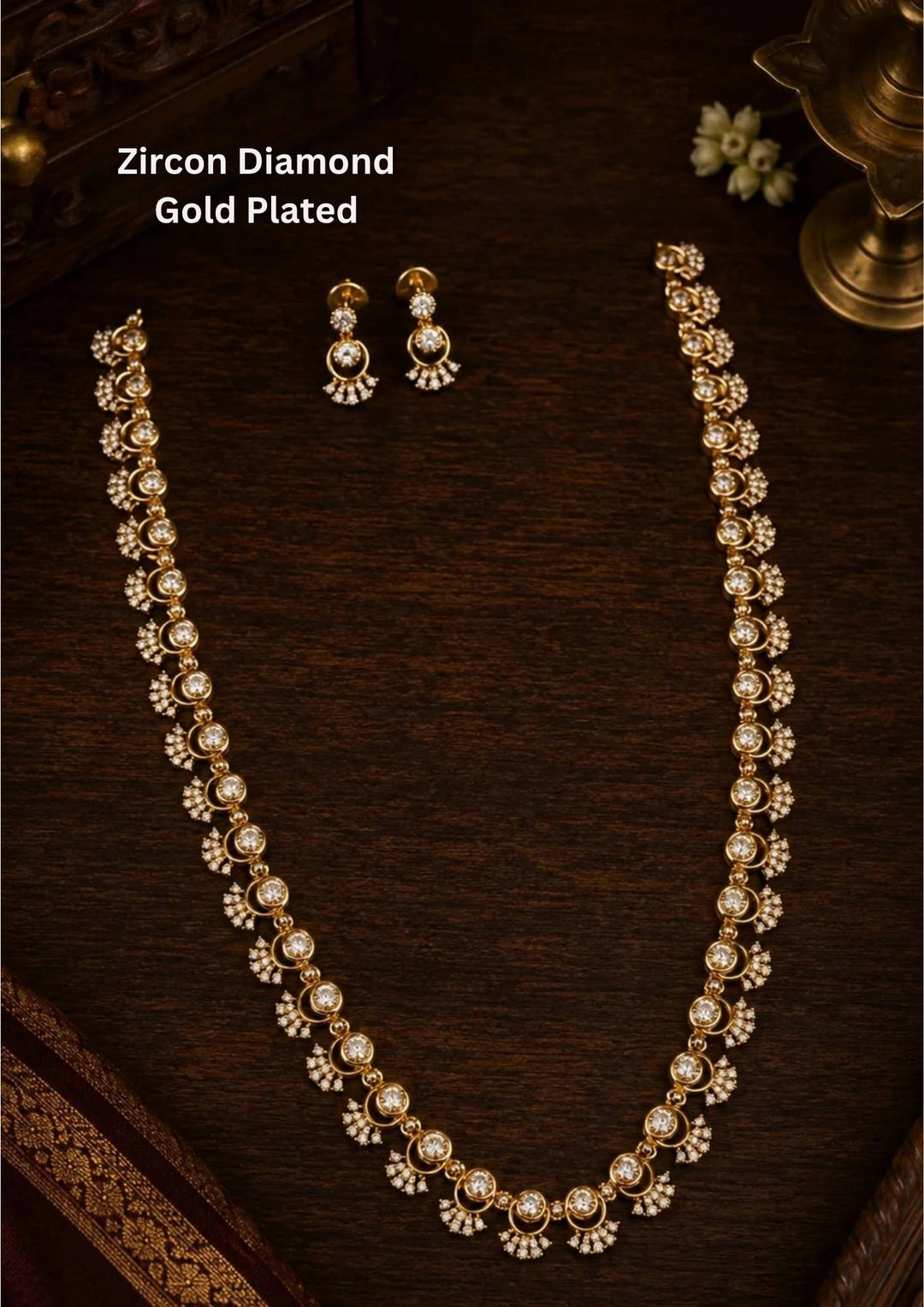 gold plated long haram necklace set highlighting a continuous single-strand link design. Each link features a brilliant round solitaire white zircon crystal nestled within a delicate, stone-studded crescent moon outline. The set includes a matching pair of two-tier hanging drop earrings that mirror the exact same celestial pattern.