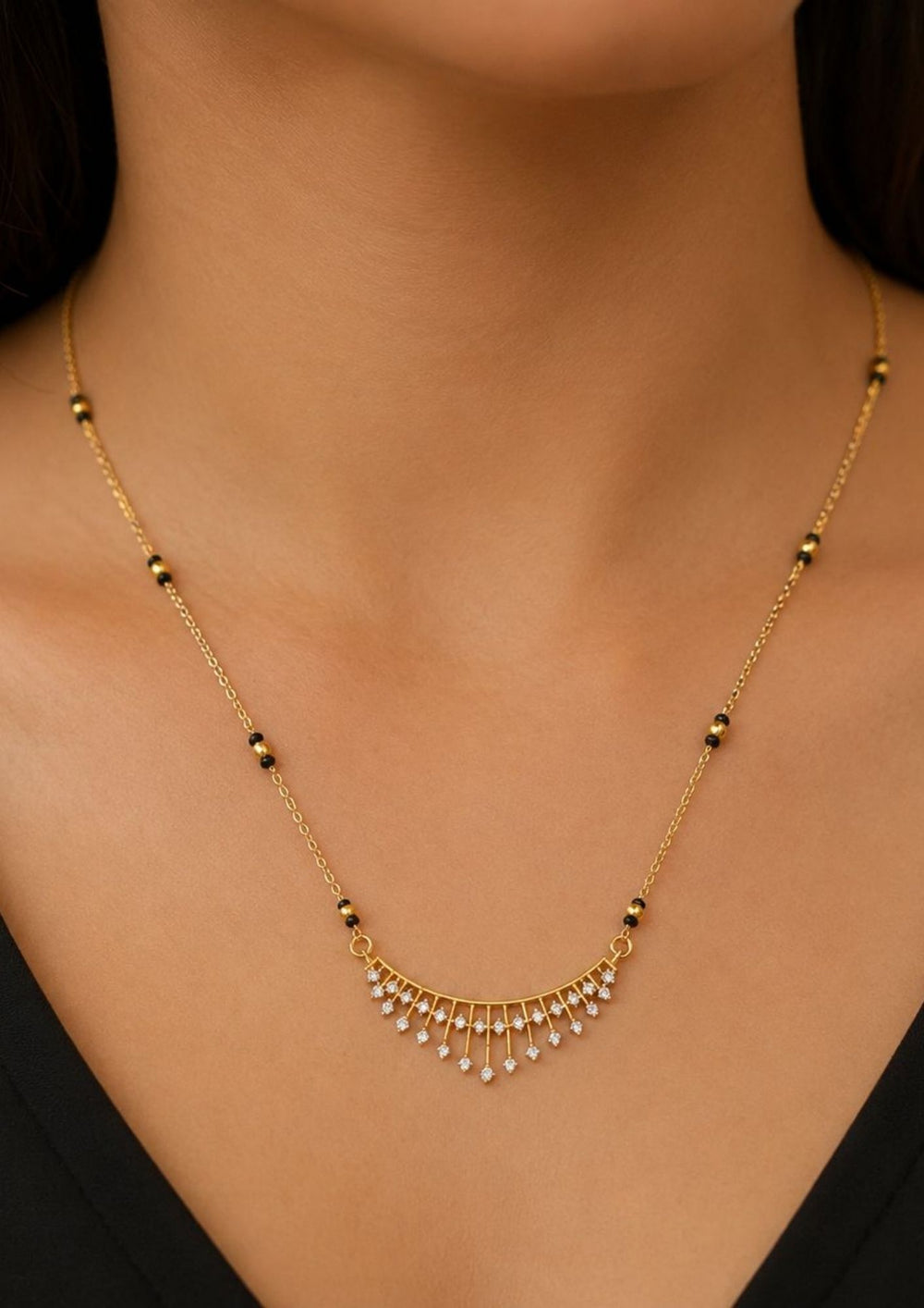 South Indian woman styling a gold plated diamond replica black beads mangalsutra chain with delicate zircon hanging drops and sleek lightweight finish. The elegant necklace combines traditional mangalsutra black bead detailing with a modern diamond look pendant, perfect for sarees, kurtis, casual ethnic wear and regular daily use.