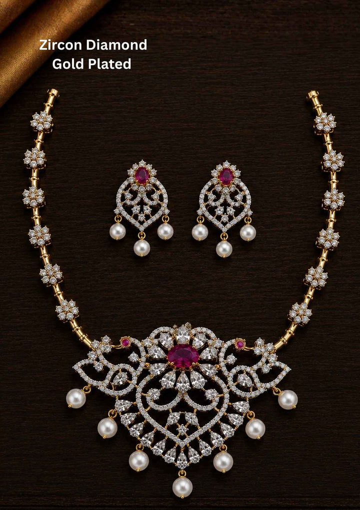 Gold-plated zircon diamond necklace and earrings comes with peacock design and shows in detailed how it look and looks and comes with red gemstone and very classy and neat finishing and can be use for festival , weeding and can gift 