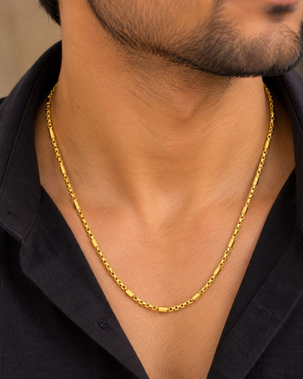 Elegant gold finish men's chain with geometric link detailing, alternating rectangular accents, and a polished finish for everyday and traditional wear.
