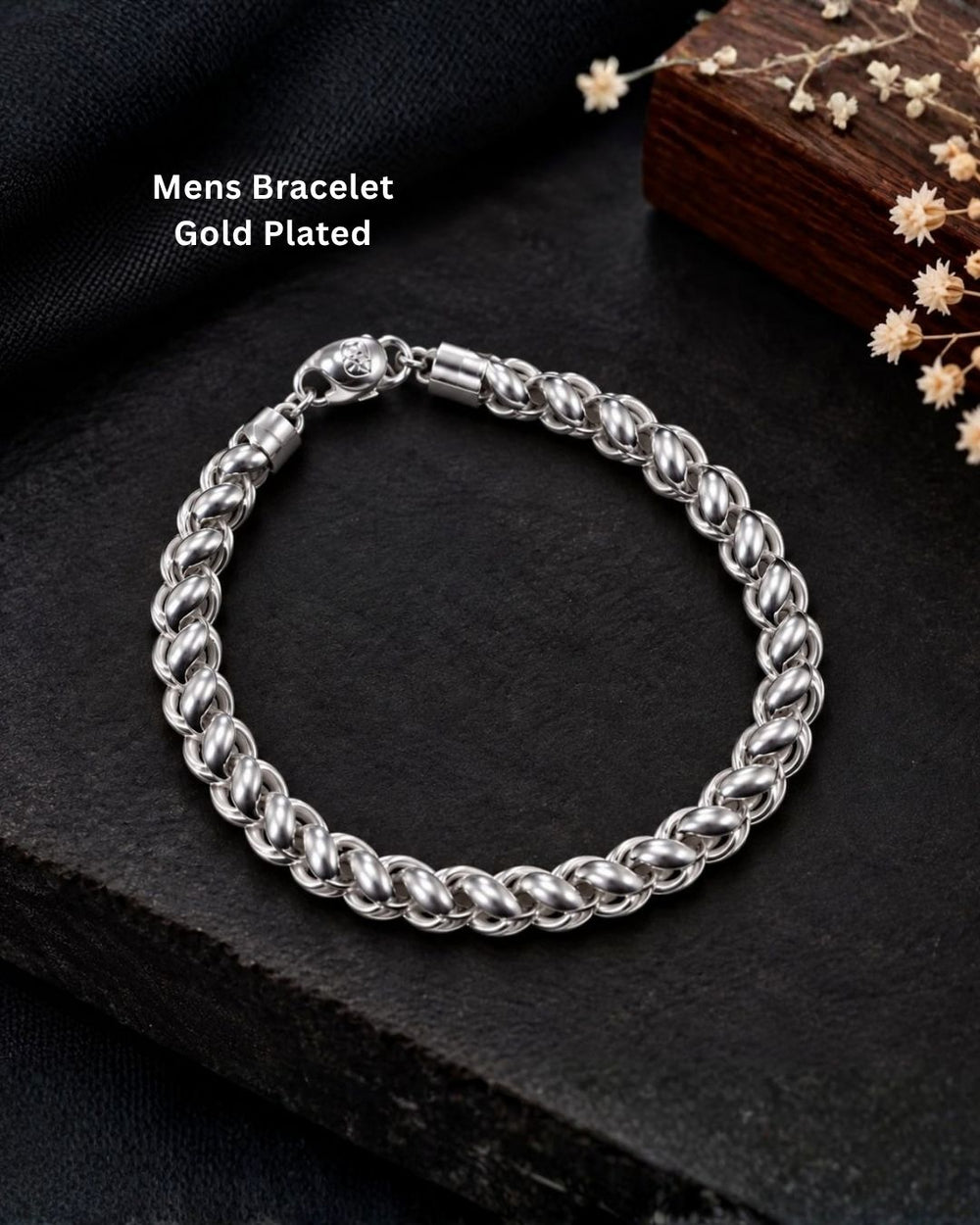 Premium silver finish men’s bracelet arranged in a circular shape on a black textured surface with decorative flowers.