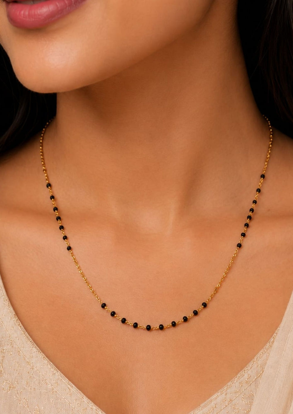 South indian women's Classic 18K gold plated black bead mangalsutra chain with a lightweight minimalist design, ideal for daily wear, office wear, festive occasions, and traditional styling.