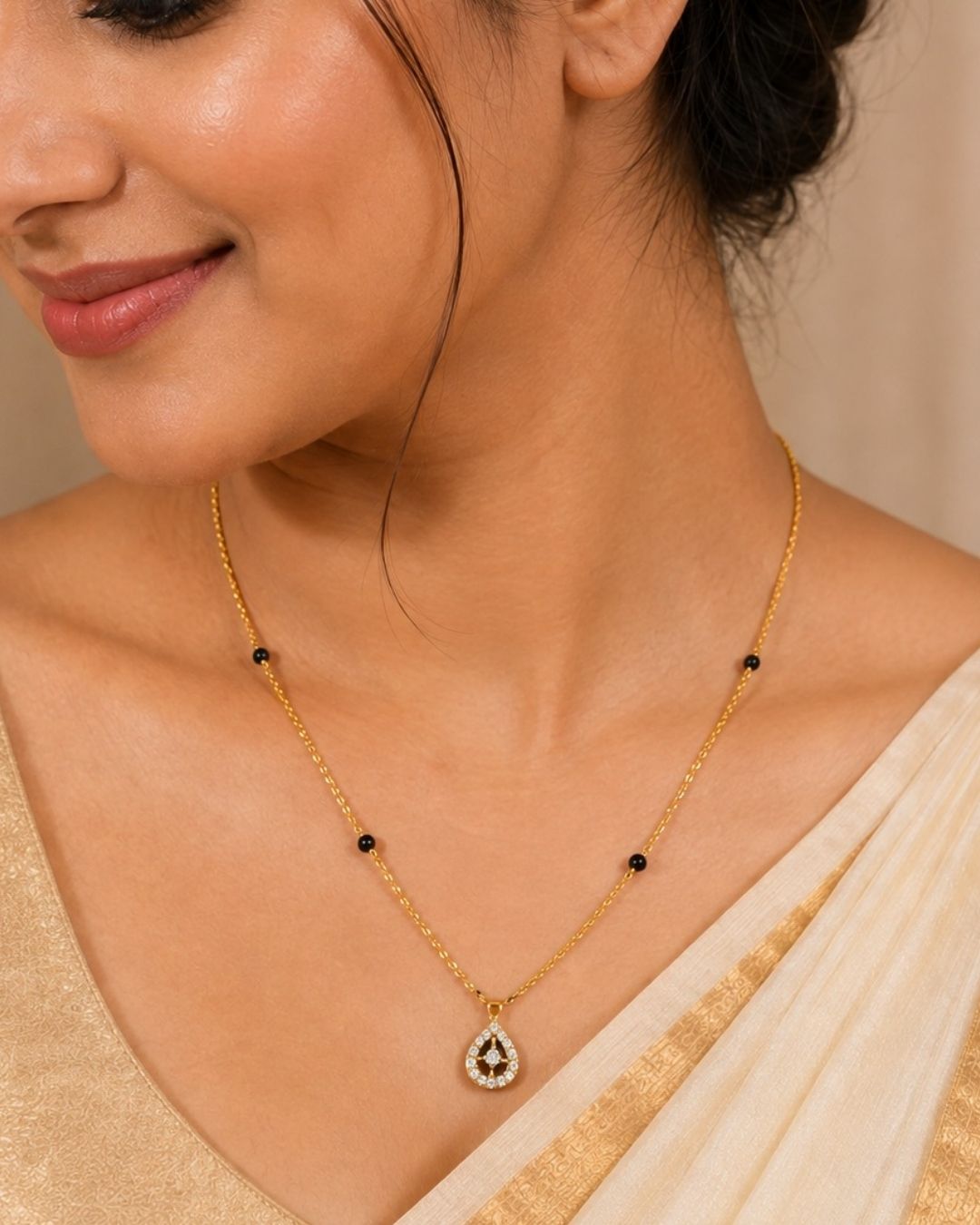 Gold-plated necklace with a teardrop-shaped zircon pendant and small black bead accents, displayed on a cream jewelry bust against a dark brown background. Text overlay reads 'Zircon Diamond Gold Plated'.