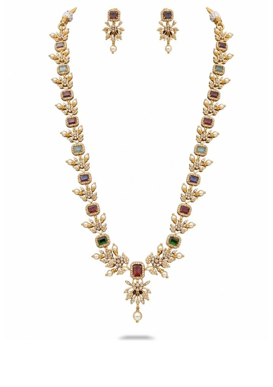 Gold necklace with gemstones and matching earrings on a white background


