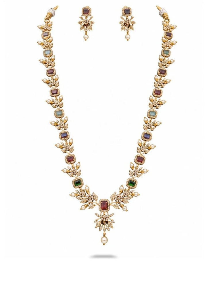 Gold necklace with gemstones and matching earrings on a white background

