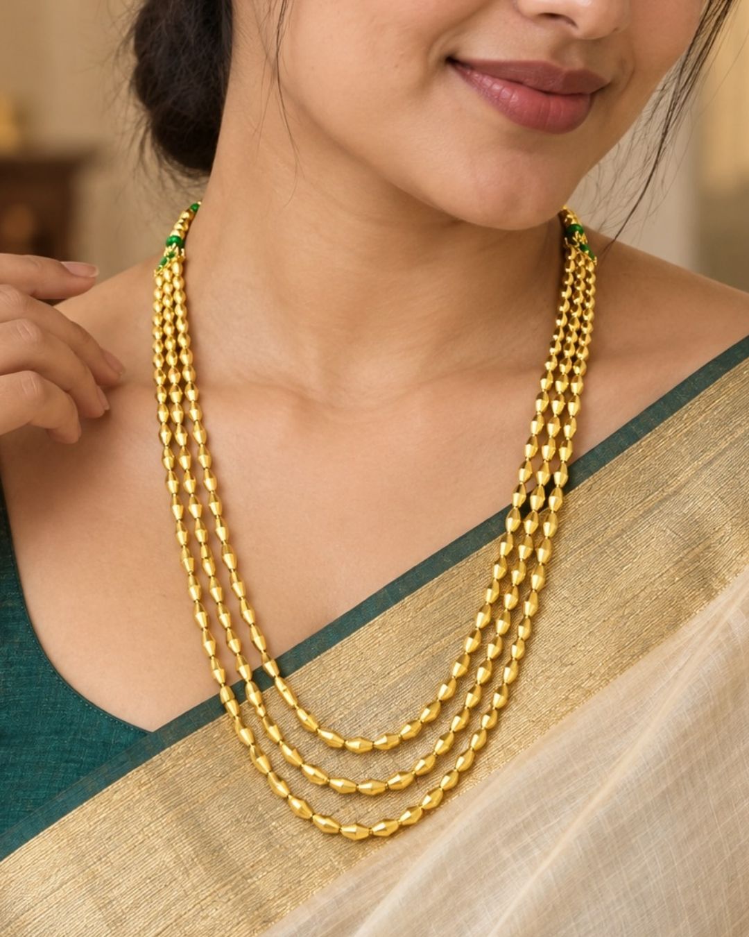 Beautiful triple strand gold beaded necklace featuring finely polished beads and a sleek layered finish. Perfect for daily wear, festive occasions, traditional outfits, temple visits, weddings, and premium gifting.