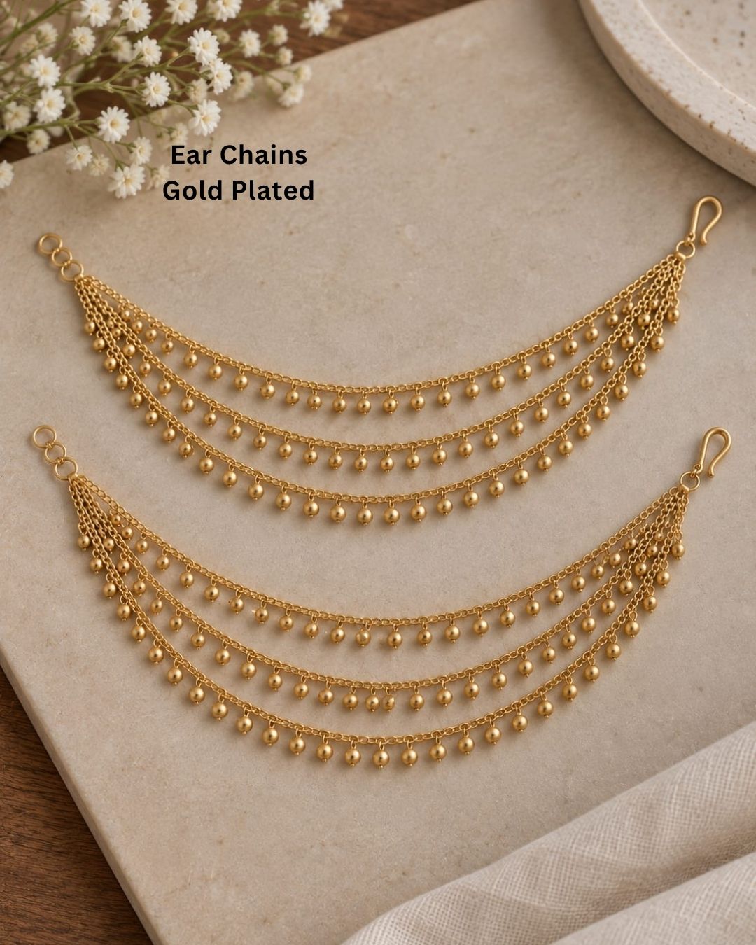 Elegant gold plated multi-layer waist chain featuring delicate dangling beads, designed to complement sarees, lehengas, and bridal attire.