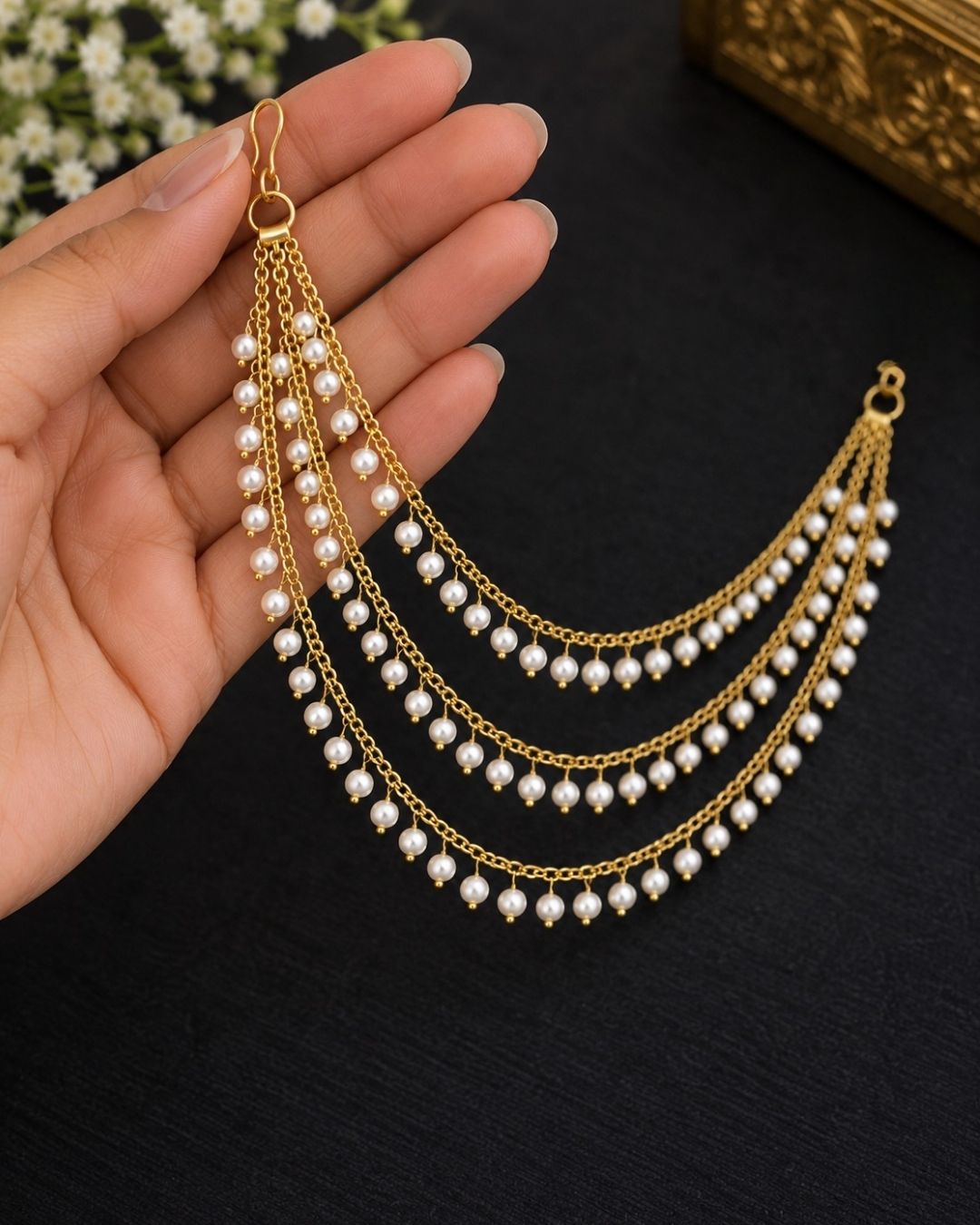 Gold-plated multi-strand chain ear chains decorated with small white pearl-like beads, displayed on a dark navy blue background with the text &