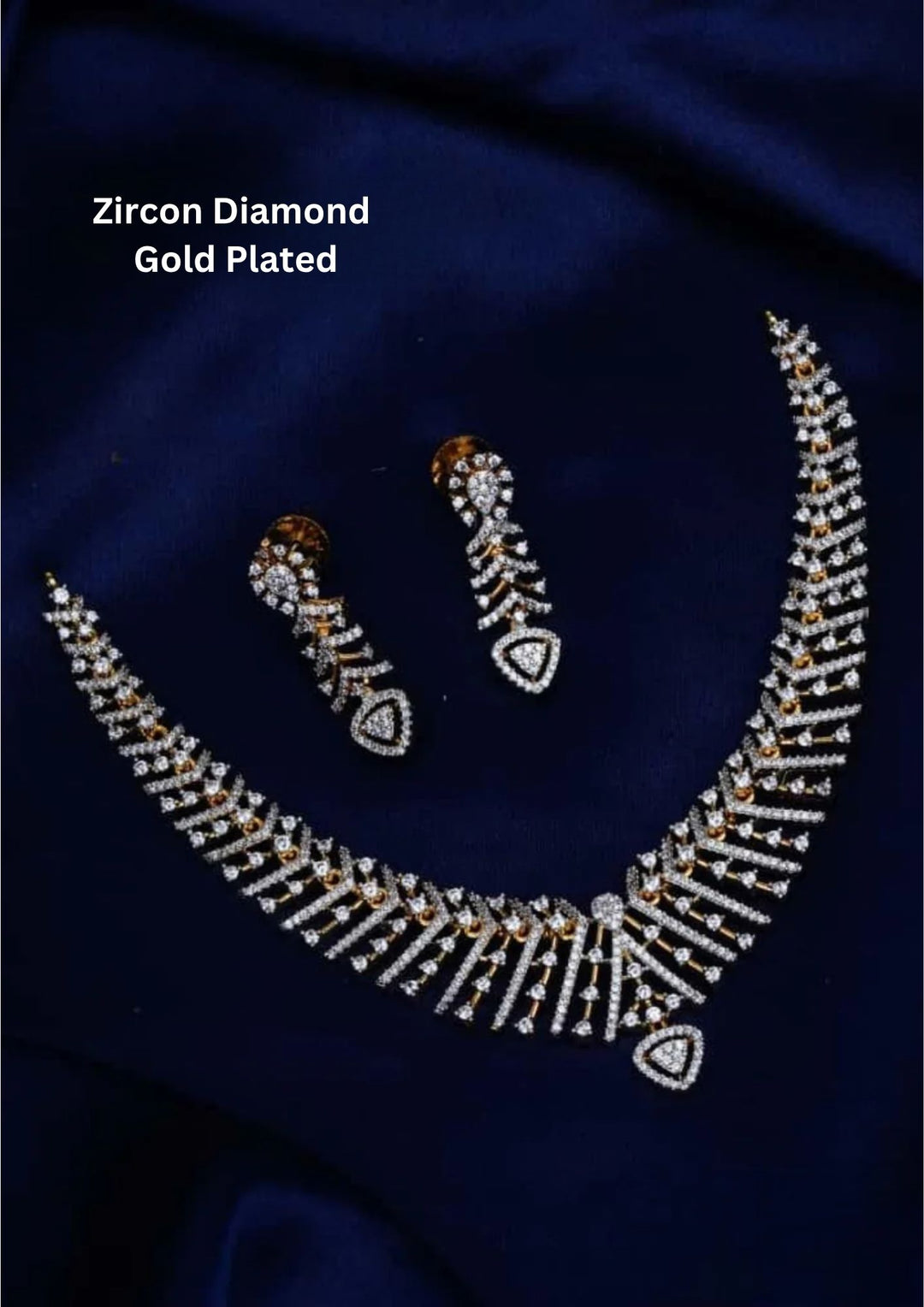 gold plated V-shaped collar necklace with a modern Art Deco aesthetic. The structured necklace features alternating diagonal bars encrusted with micro pure Zirconian diamonds, creating a shimmering chevron fringe that culminates in a central teardrop crystal pendant, complete with matching drop earrings.