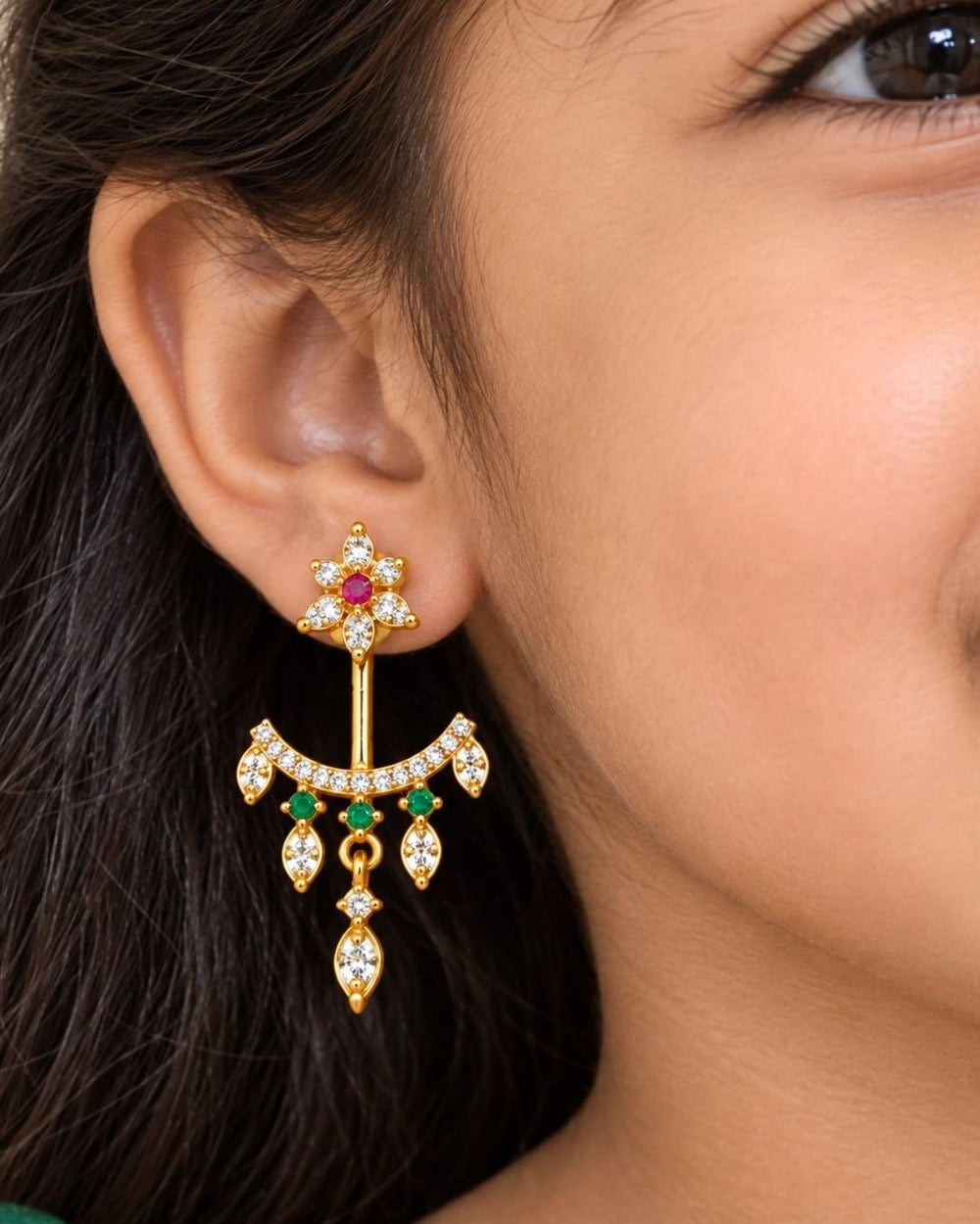 Beautiful gold plated designer dangler earrings featuring intricate floral detailing, sparkling CZ stones, pink and green accents, and delicate hanging drops. Perfect for festive occasions, parties, traditional wear, and gifting.