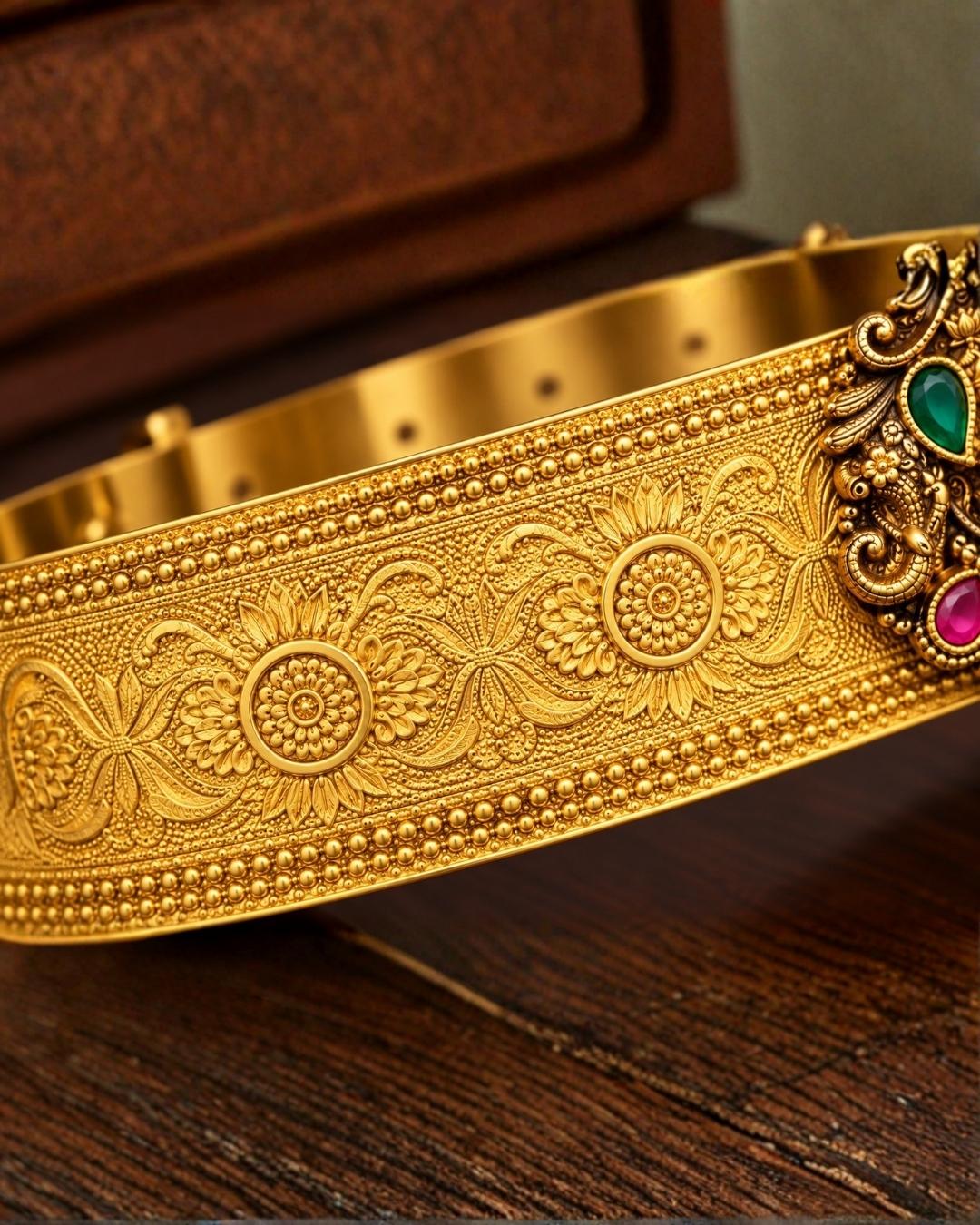Beautiful gold plated kid’s hip belt featuring a wide engraved band with a traditional Lakshmi centerpiece decorated with ruby and green stones. Perfect for traditional wear, weddings, festive occasions, cultural events, parties, and gifting.