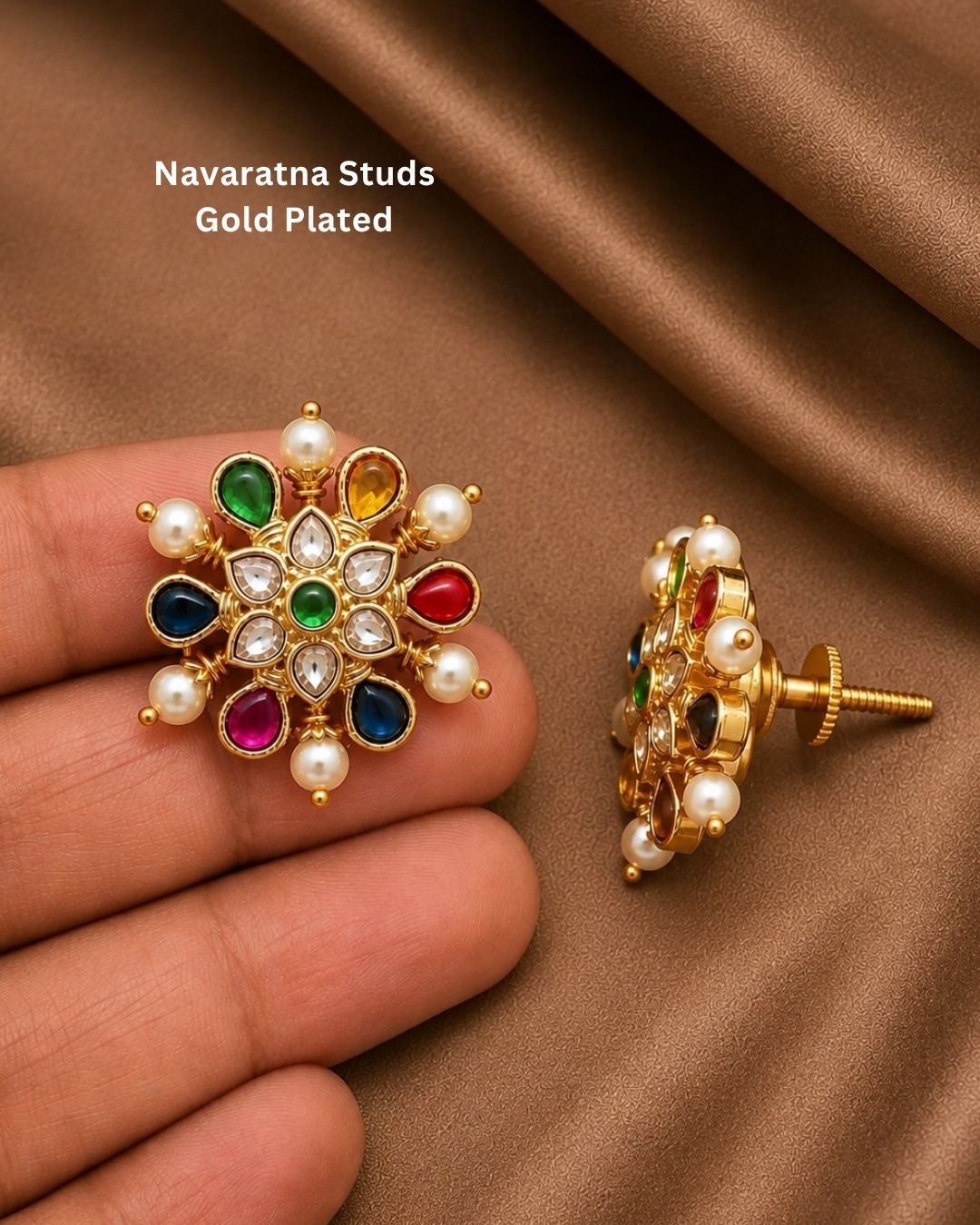 Beautiful Navratna pearl gold plated stud earrings featuring intricate floral craftsmanship, multicolor gemstone accents, sparkling white stones, and elegant pearl detailing. Perfect for weddings, festive occasions, traditional outfits, temple visits, and premium gifting.