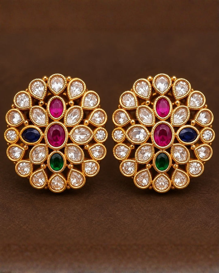 South Indian Woman wearing a gold plated navaratna set with matching studs . this chain was designed in flower model and gemestones are placed inrectangular cuts and this chain cam ewith matching studs that are designed in flower shapr with zircon stones thhis is anti fade color and partywear, receptions and perfect for weddings