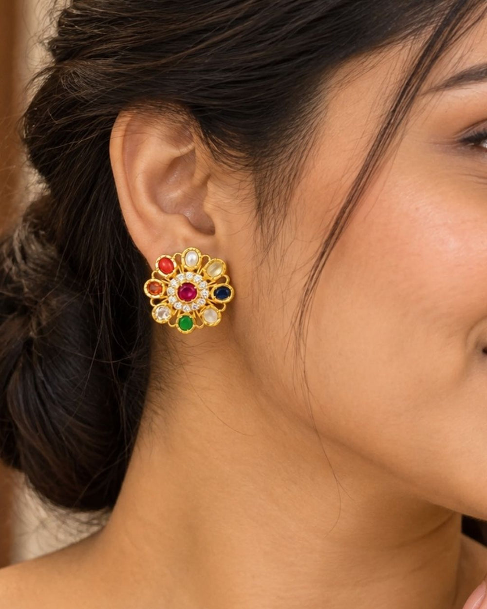 Beautiful gold plated floral earrings featuring a ruby-tone center, vibrant red, blue, green, and clear stones, pearl accents, and sparkling crystal detailing, perfect for festive occasions, weddings, parties, and traditional looks.