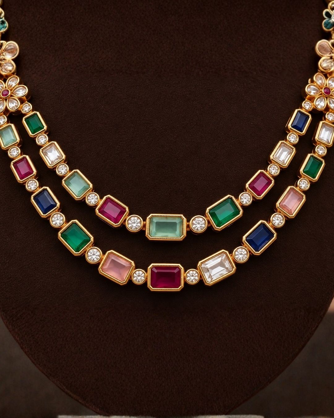 South Indian Woman wearing a gold plated navaratna set with matching studs . this chain was designed in flower model and gemestones are placed inrectangular cuts and this chain cam ewith matching studs that are designed in flower shapr with zircon stones thhis is anti fade color and partywear, receptions and perfect for weddings