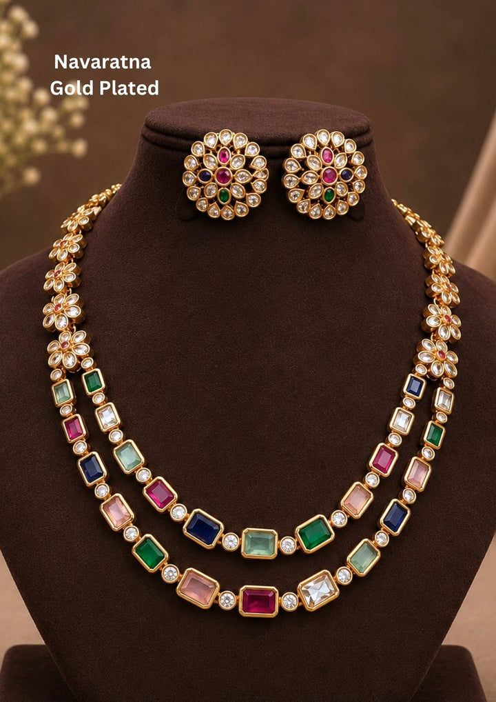 gold plated navaratna set with matching studs . this chain was designed in flower model and gemestones are placed inrectangular cuts and this chain cam ewith matching studs that are designed in flower shapr with zircon stones thhis is anti fade color and partywear, receptions and perfect for weddings.