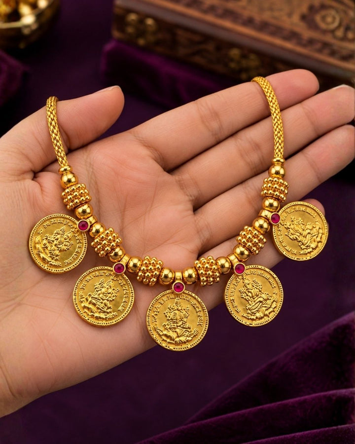 Gold plated Laxmi coin necklace featuring traditional Lakshmi motif coins with elegant temple-inspired craftsmanship. Perfect for festivals, poojas and traditional occasions.