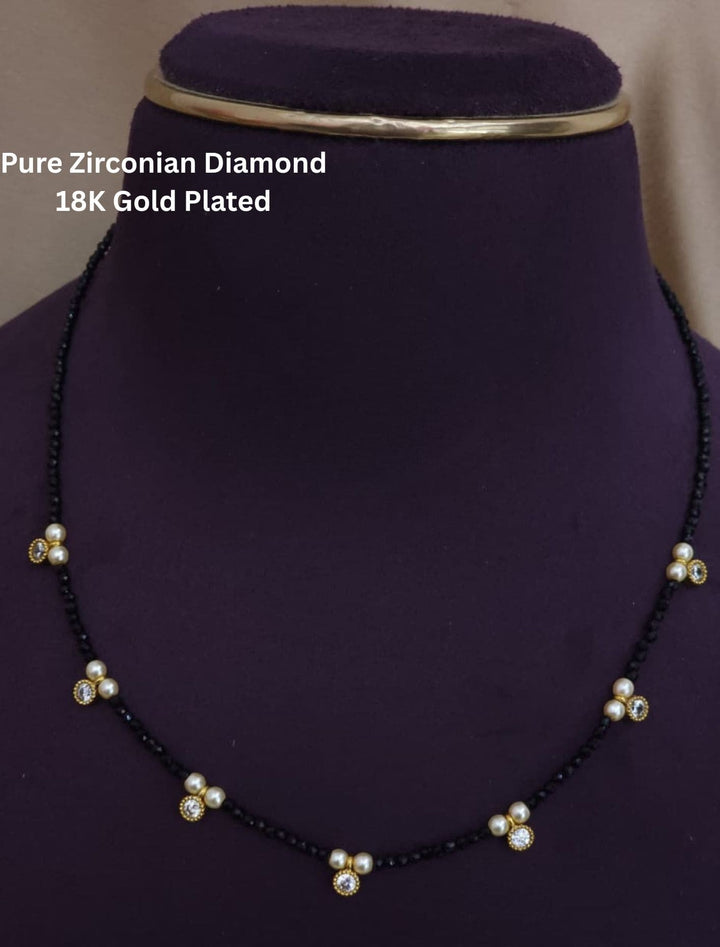 Necklace with black beads and gold plating