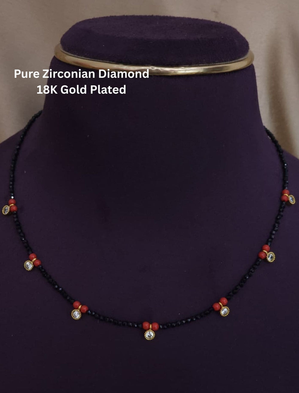 Necklace with black beads and red accents