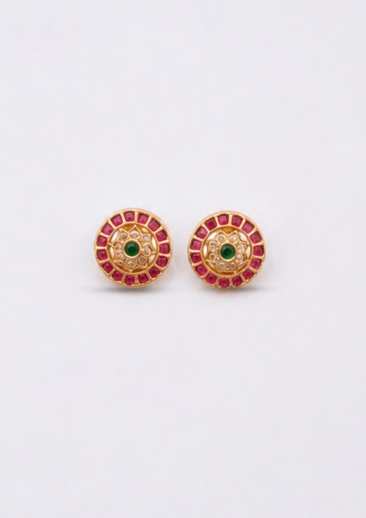 Pair of earrings with red and green gemstones on a white background