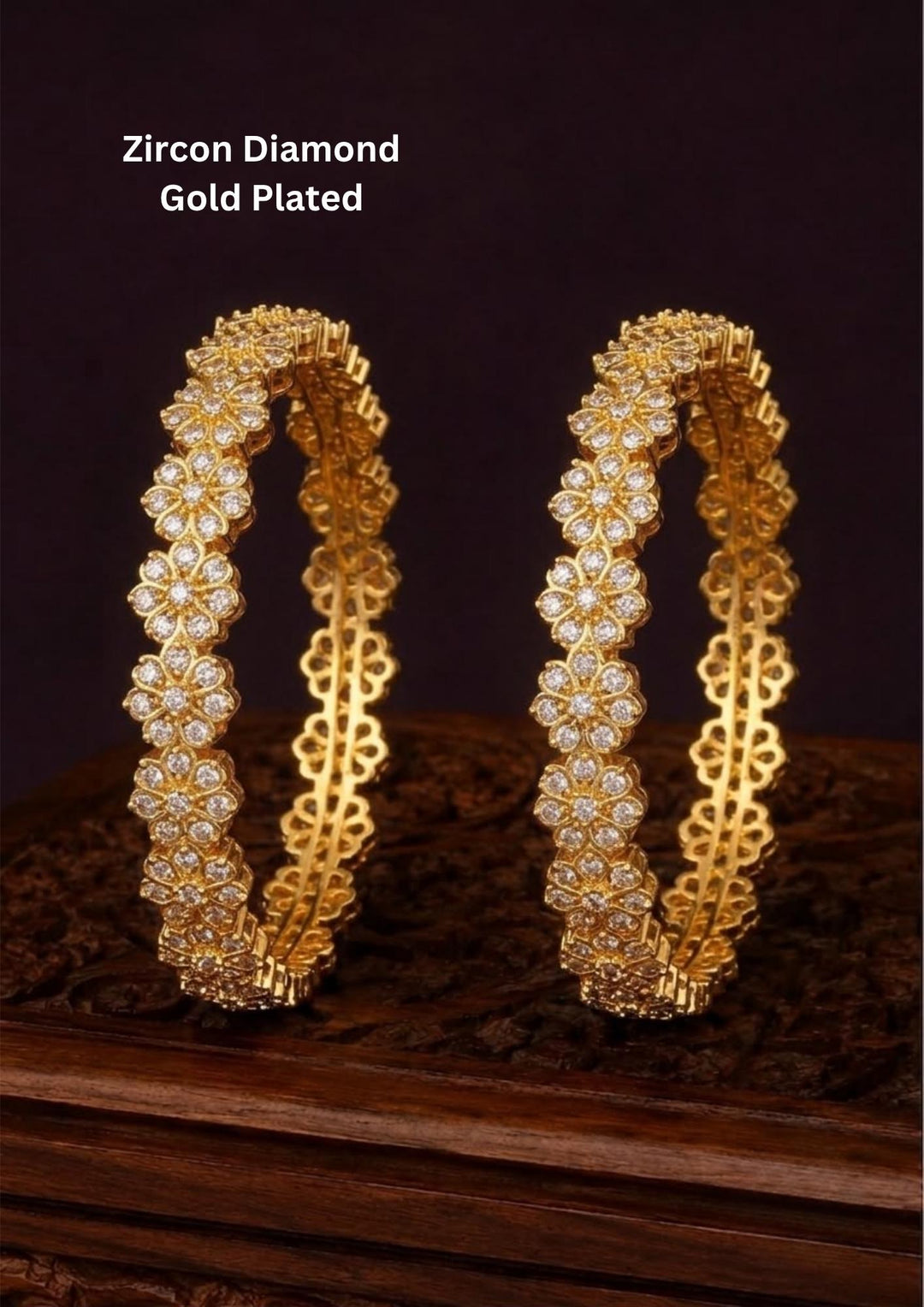 A pair of gold-plated bangles decorated with clear zirconia stones in a floral pattern, Beautiful zircon diamond gold plated floral bangles featuring continuous sparkling flower motifs and premium craftsmanship. Perfect for weddings, festivals, parties, and elegant everyday styling.