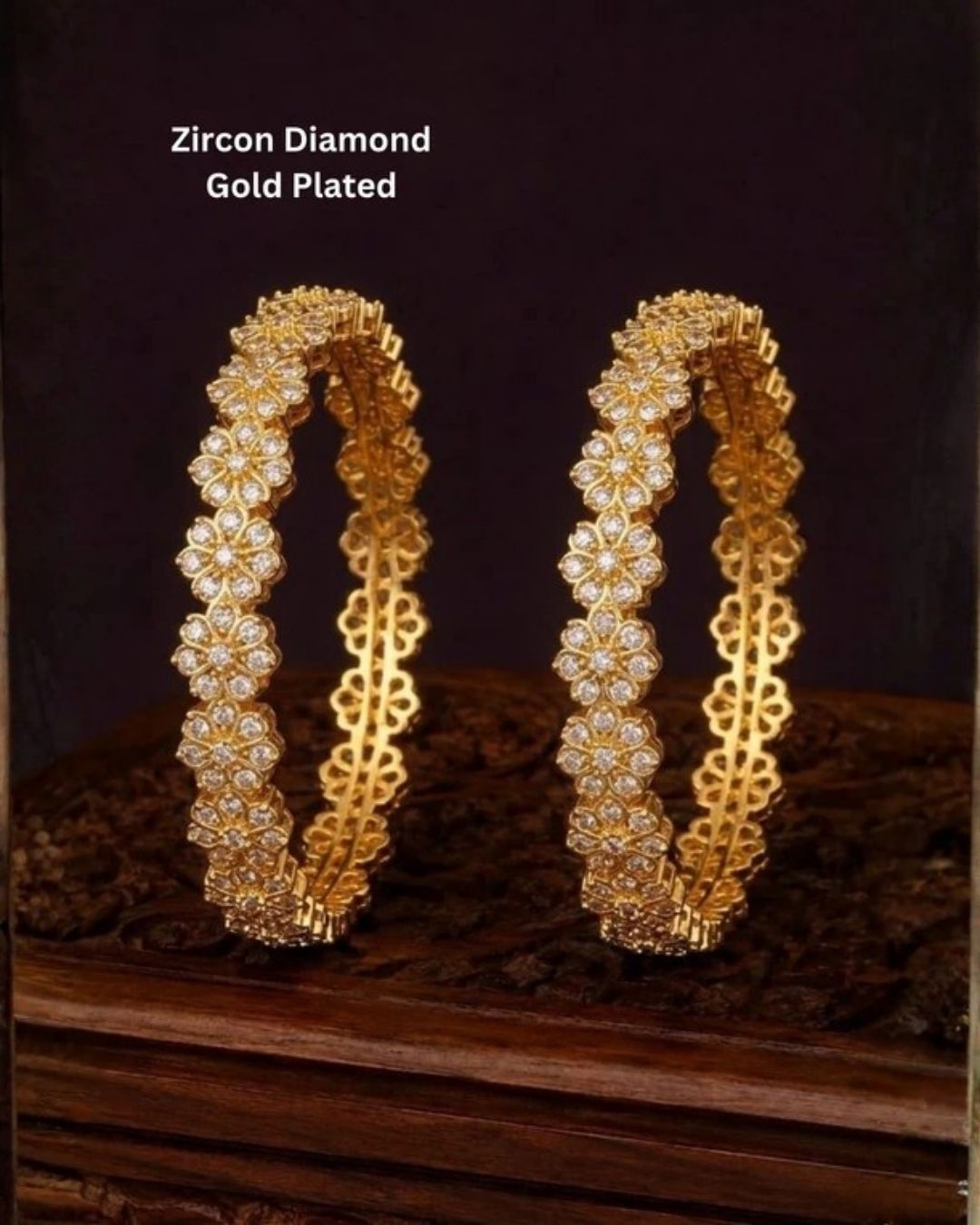 A pair of gold-plated bangles decorated with clear zirconia stones in a floral pattern, Beautiful zircon diamond gold plated floral bangles featuring continuous sparkling flower motifs and premium craftsmanship. Perfect for weddings, festivals, parties, and elegant everyday styling.
