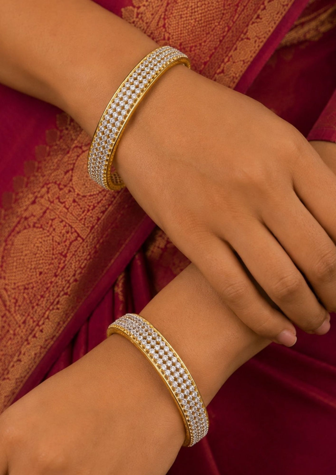 South indian women wearing a Designer zircon stone gold plated bangles crafted with intricate detailing and shimmering white stones throughout. The lightweight yet glamorous style pairs beautifully with sarees, lehengas and contemporary ethnic outfits.