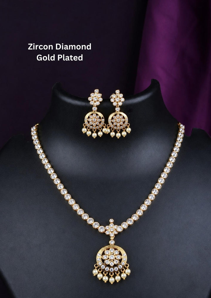 Gold plated zircon diamond necklace set featuring a sparkling floral pendant with pearl drops and matching earrings. Beautifully crafted with premium zircon stones, making it ideal for weddings, festive celebrations, receptions, and traditional occasions.