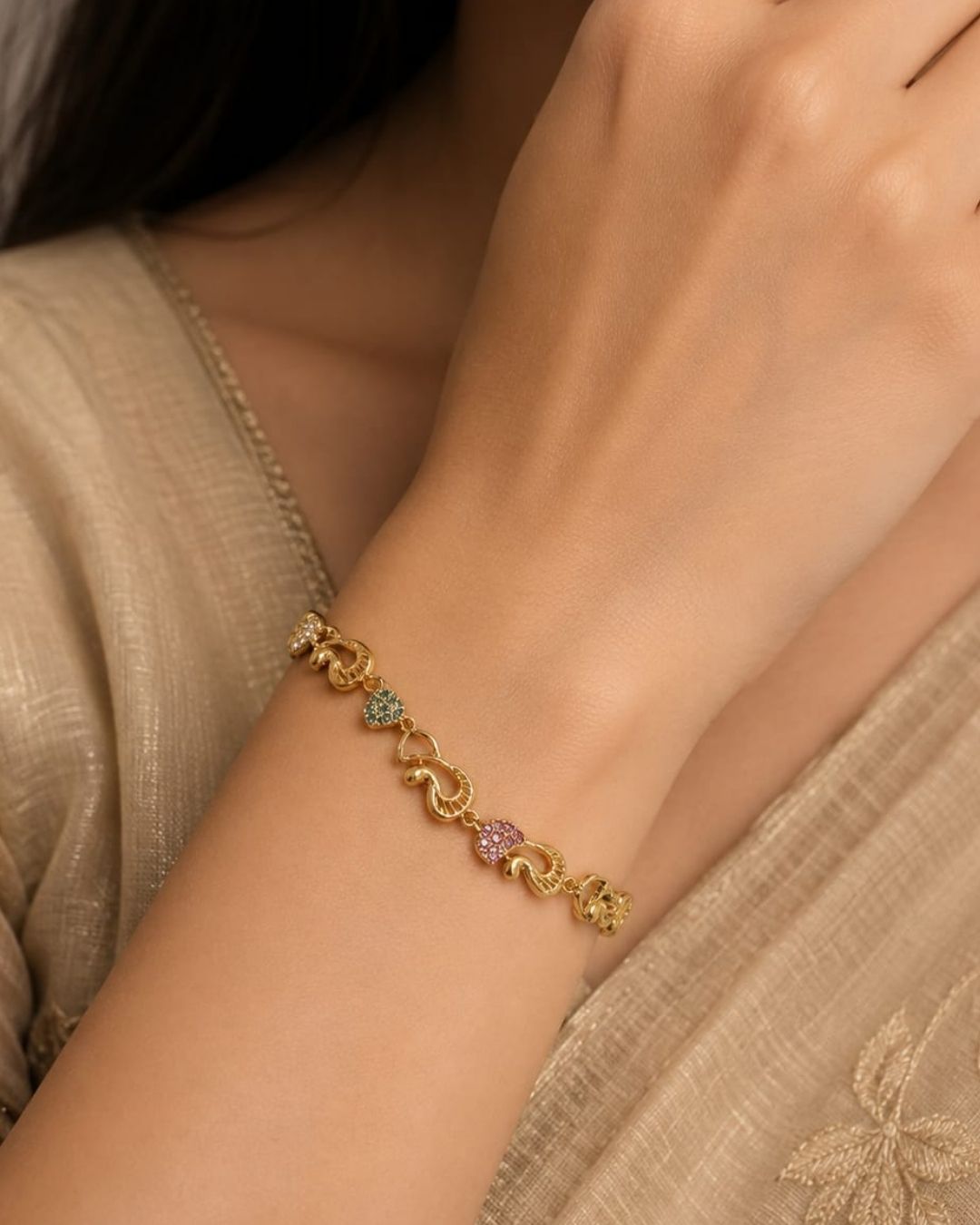 Stylish gold plated peacock design bracelet featuring intricate traditional motifs, vibrant green and ruby stone accents, sparkling white detailing, and an elegant linked pattern. Perfect for festive occasions, traditional outfits, weddings, parties, and special events.