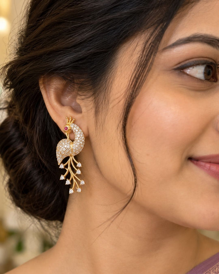 Premium peacock-inspired necklace set crafted with shimmering zircon stones and matching earrings. Beautiful zircon diamond gold plated peacock necklace set featuring elegant leaf patterns, sparkling zircon stones, and matching peacock earrings. Perfect for weddings, receptions, festive occasions, and party wear.