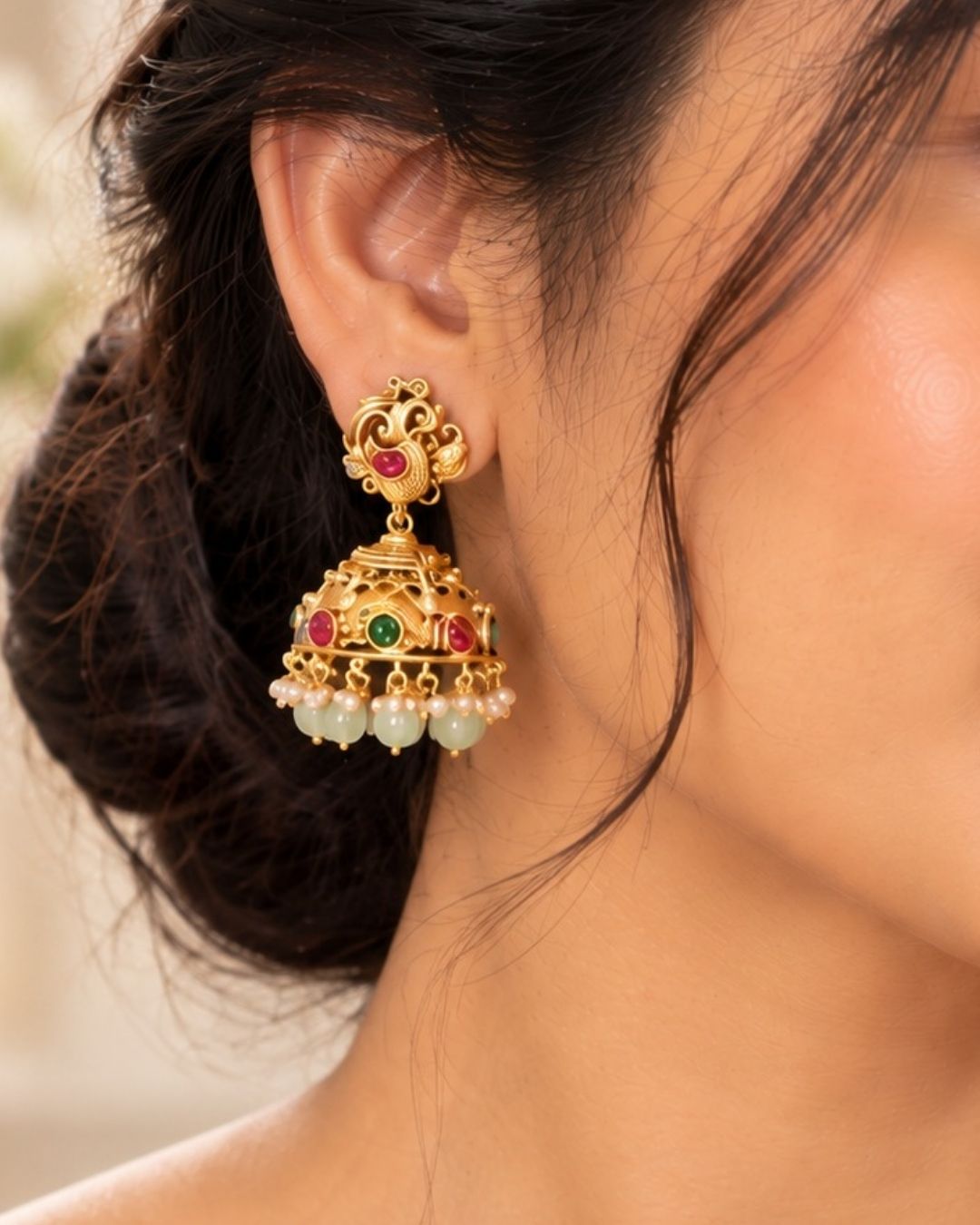 Jadau Kundan Gold Plated Laxmi Temple necklace set with matching jhumka earrings designed with three  rows of pastel green beads and gold pearls with gold pendant with Goddess Laxmi, peacocks, ruby red stones, and hanging bead drops. perfect for weddings, festivals, receptions, and cultural South Indian jewellery styling.
