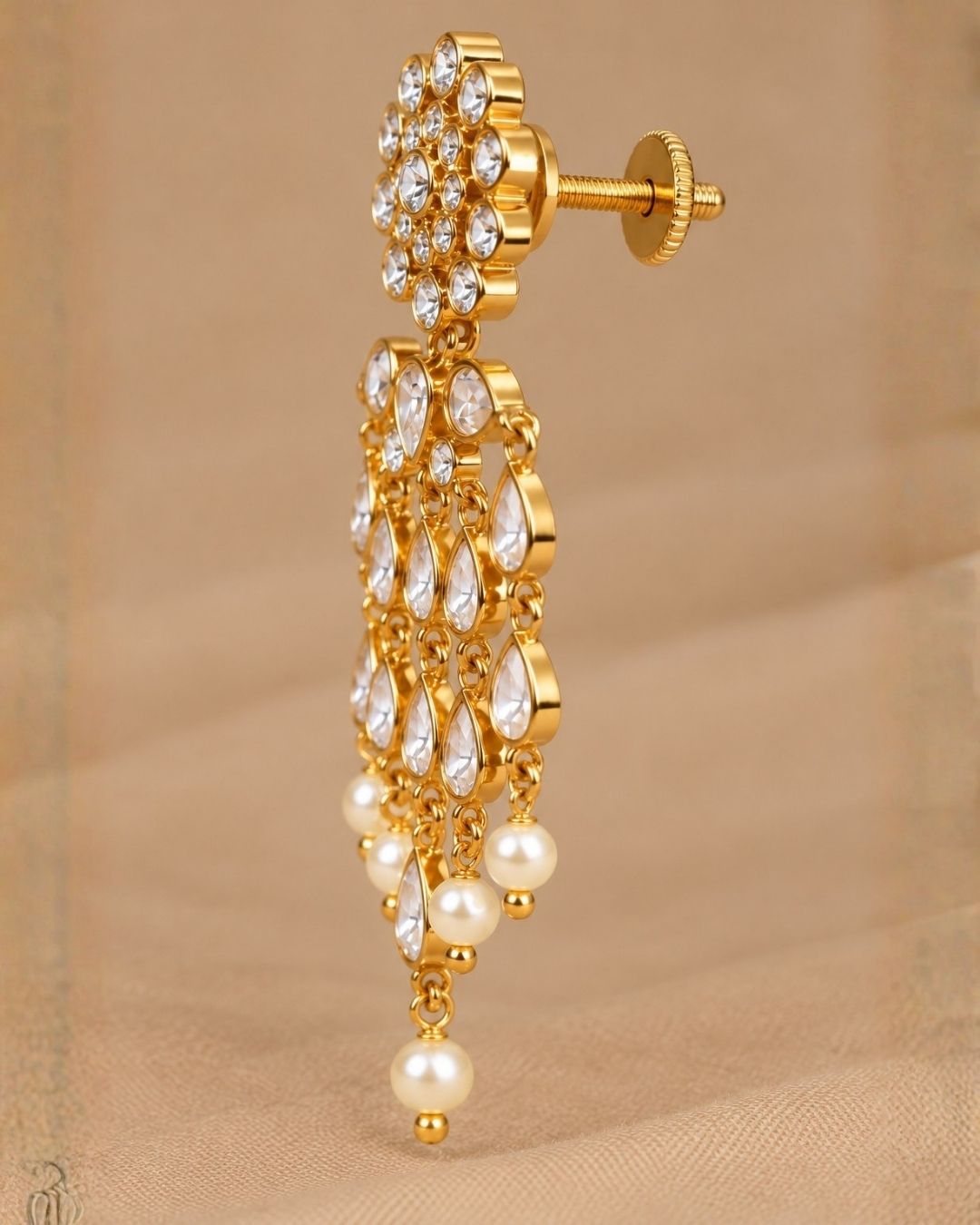  Close up offer south indian women wearing Beautiful zircon diamond gold plated chandelier earrings featuring dazzling pear-shaped zircon stones with graceful pearl drops. Perfect for weddings, receptions, parties, festive occasions, and premium gifting.