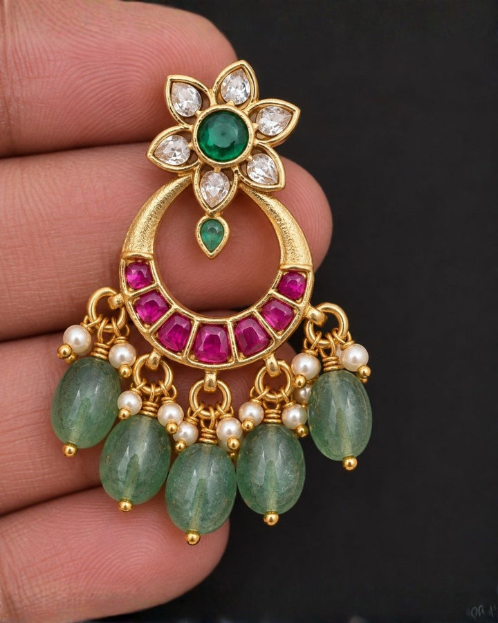 South Indain Women wearing Earring of a pair of Jadau Kundan 18k gold plated chandbali earrings showing pink and green stone clusters that give a graceful traditional and modern look for family events and weddings with COD.
