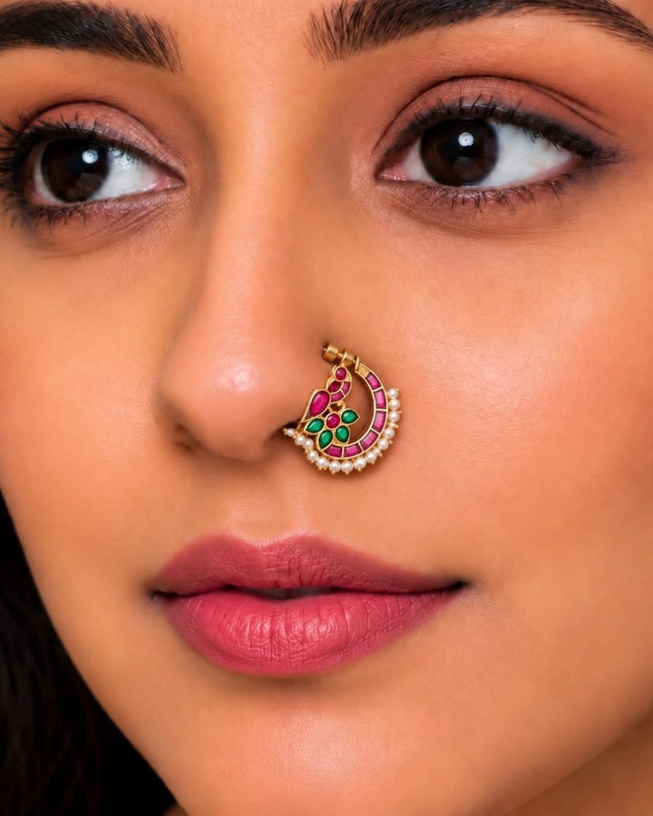 Traditional gold plated crescent nose pin featuring vibrant pink and green stones with a row of white pearls along the bottom.