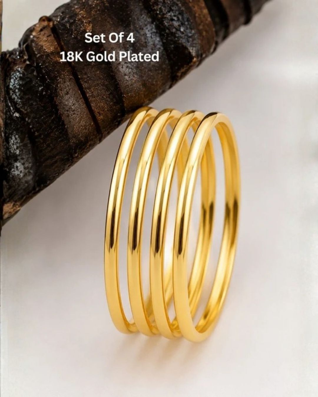 Four slim gold-plated rings stacked together Classic gold plated bangles with intricate engraved detailing for a timeless traditional look.