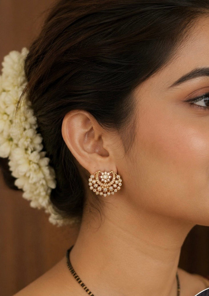 Close-up of a woman's ear with gold earrings 