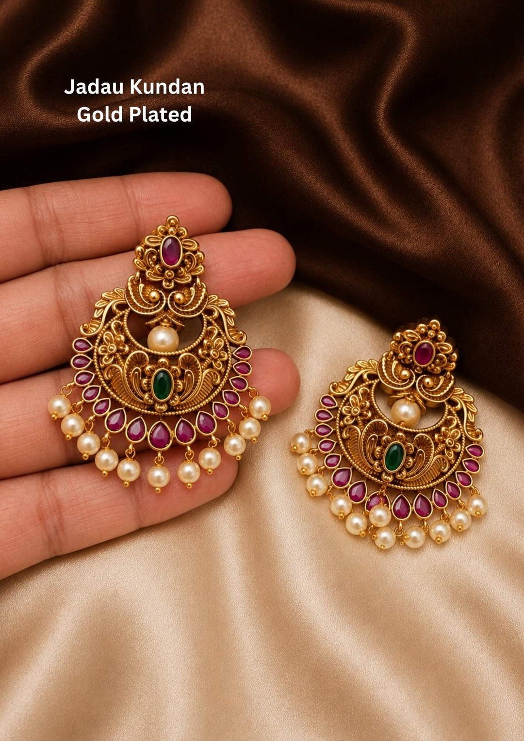 gold plated brass base chandbali earrings featuring vibrant pink ruby and green stone accents with delicate pearl droplet hangings. These lightweight antique earrings are designed with intricate traditional carvings and a premium matte gold finish suitable for weddings, festivals, poojas, family functions, sarees, and ethnic outfits with skin-friendly quality, anti-fade polish, comfortable fitting