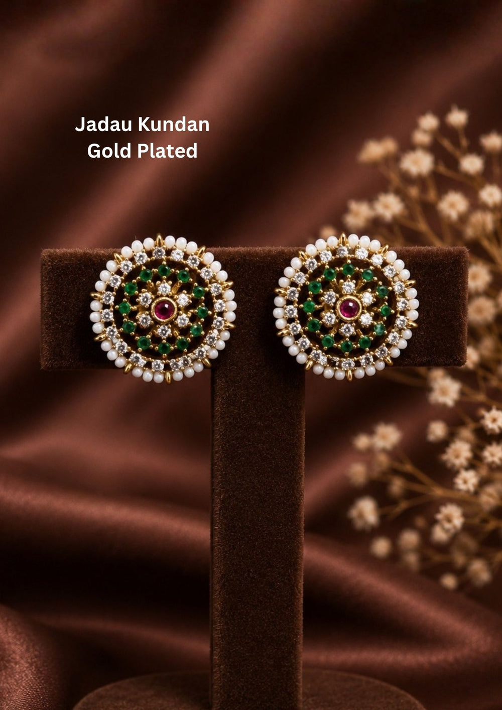 Elegant Jadau Kundan gold-plated stud earrings styled with traditional floral cluster patterns, with Emerald Green stone settings, and a pearl halo. Perfect for festive celebrations, weddings, ethnic wear, and luxury gifting.