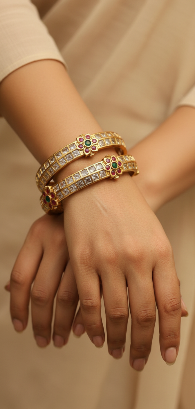 Designer Jadau Kundan bangles with brilliant square zircon stones, ruby and emerald floral centerpiece, perfect for festive and wedding wear.