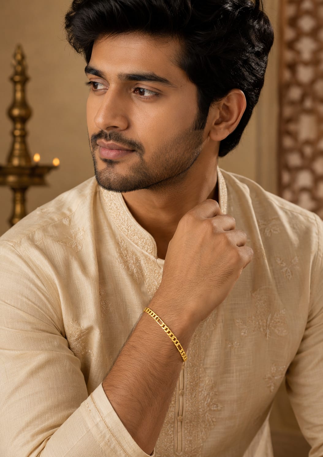 Close up of south indian men wrist wearing An elegant, sleek 18k gold-plated bracelet  features a continuous, sophisticated pattern of repeating cylindrical bar links seamlessly interconnected with small circular loops, offering a clean and polished modern look. Perfect for daily wear or for pairing with your favorite pendant.