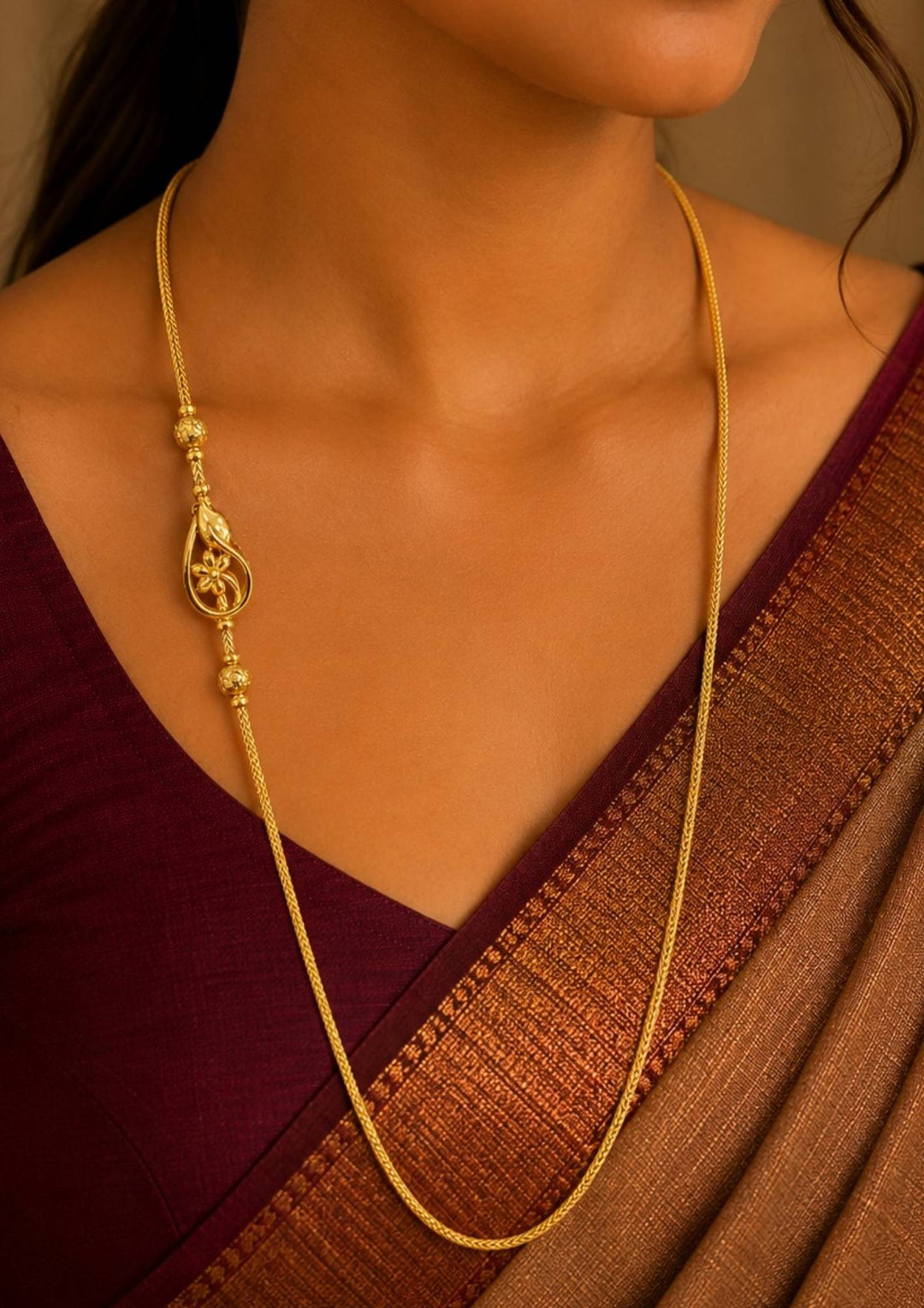 South Indian Women wearing 18K gold plated thalli chain featuring an elegant floral pendant with decorative gold bead accents and premium craftsmanship for festive and daily wear , office wear.