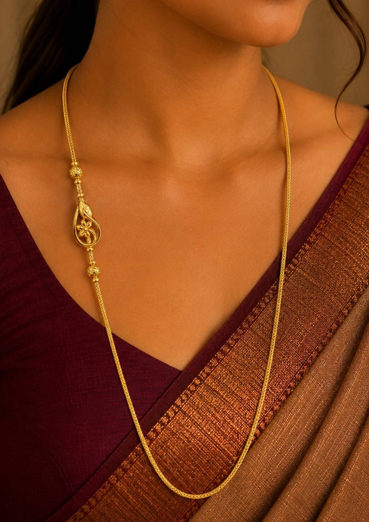 South Indian Women wearing 18K gold plated thalli chain featuring an elegant floral pendant with decorative gold bead accents and premium craftsmanship for festive and daily wear , office wear.