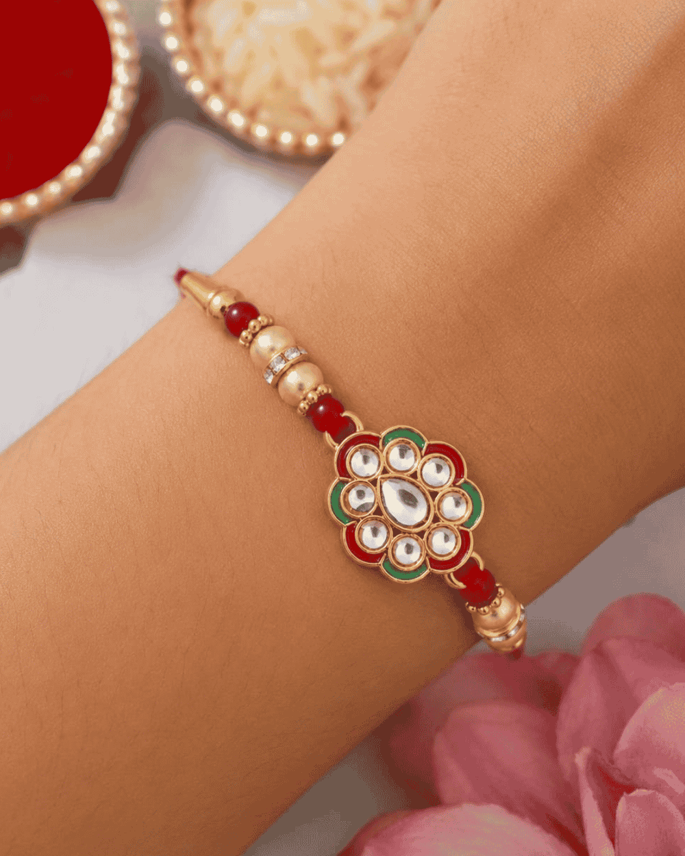 Elegant Floral Stone Rakhi showcasing a sparkling floral centerpiece with premium stone embellishments, golden beads, and a festive handcrafted design.