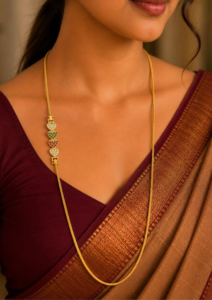 South Indian omen wearing 18K gold plated thalli chain featuring sparkling multicolor heart motifs with elegant craftsmanship and premium finish for festive and daily wear.