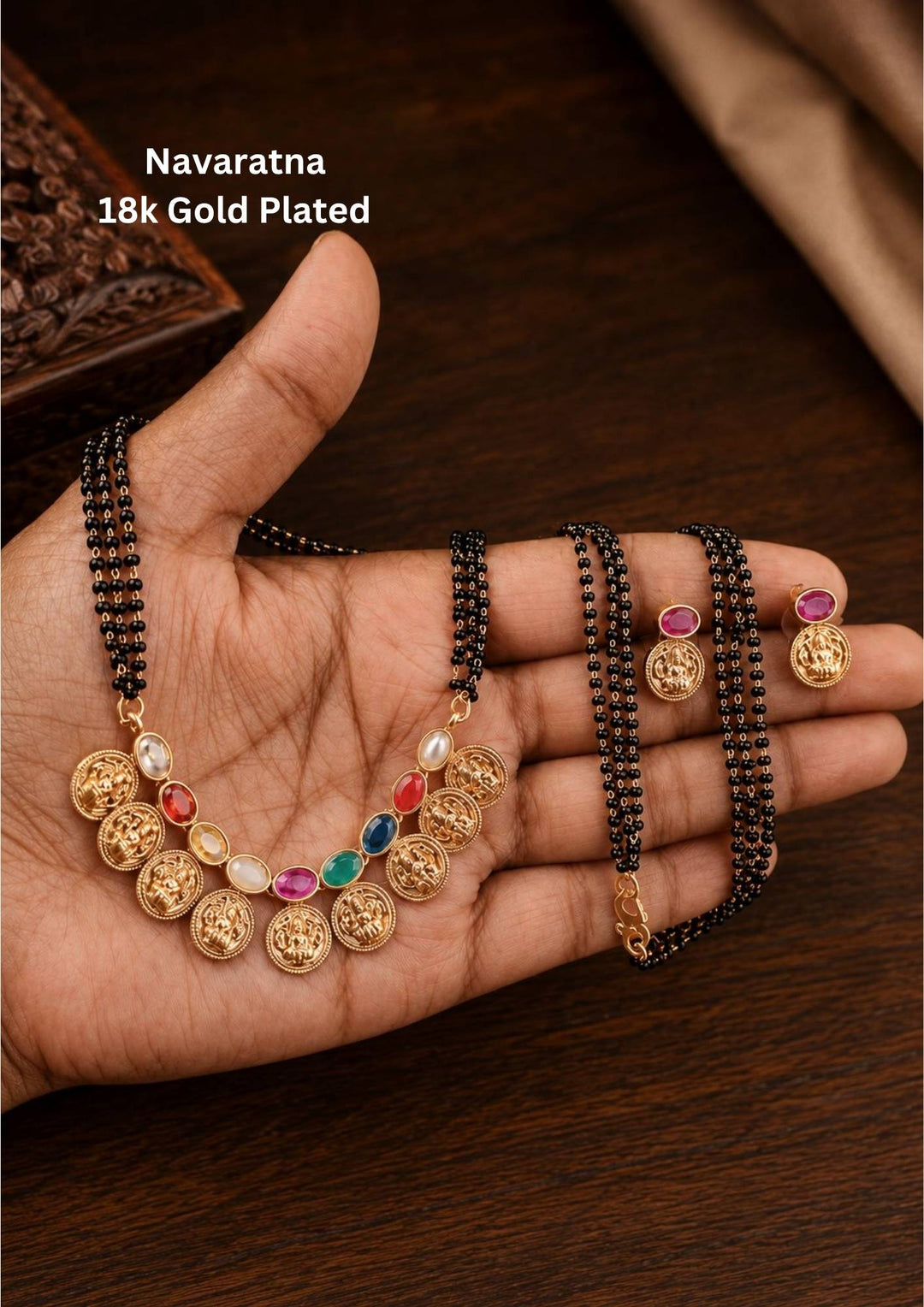 Traditional style 18k gold plated Navaratna mangalsutra set designed with a multi-layered black bead chain, continuous Laxmi coin charms, and colorful nine-gemstone accents that give a graceful traditional look for daily fashion wear, festive celebrations, poojas, family functions, and bridal outfits.