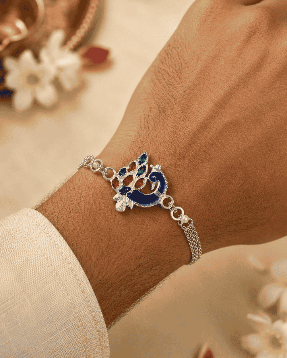 Beautiful Peacock silver plated Rakhi featuring a colorful enamel peacock design and bracelet-style chain. Perfect for Raksha Bandhan celebrations and thoughtful gifting.