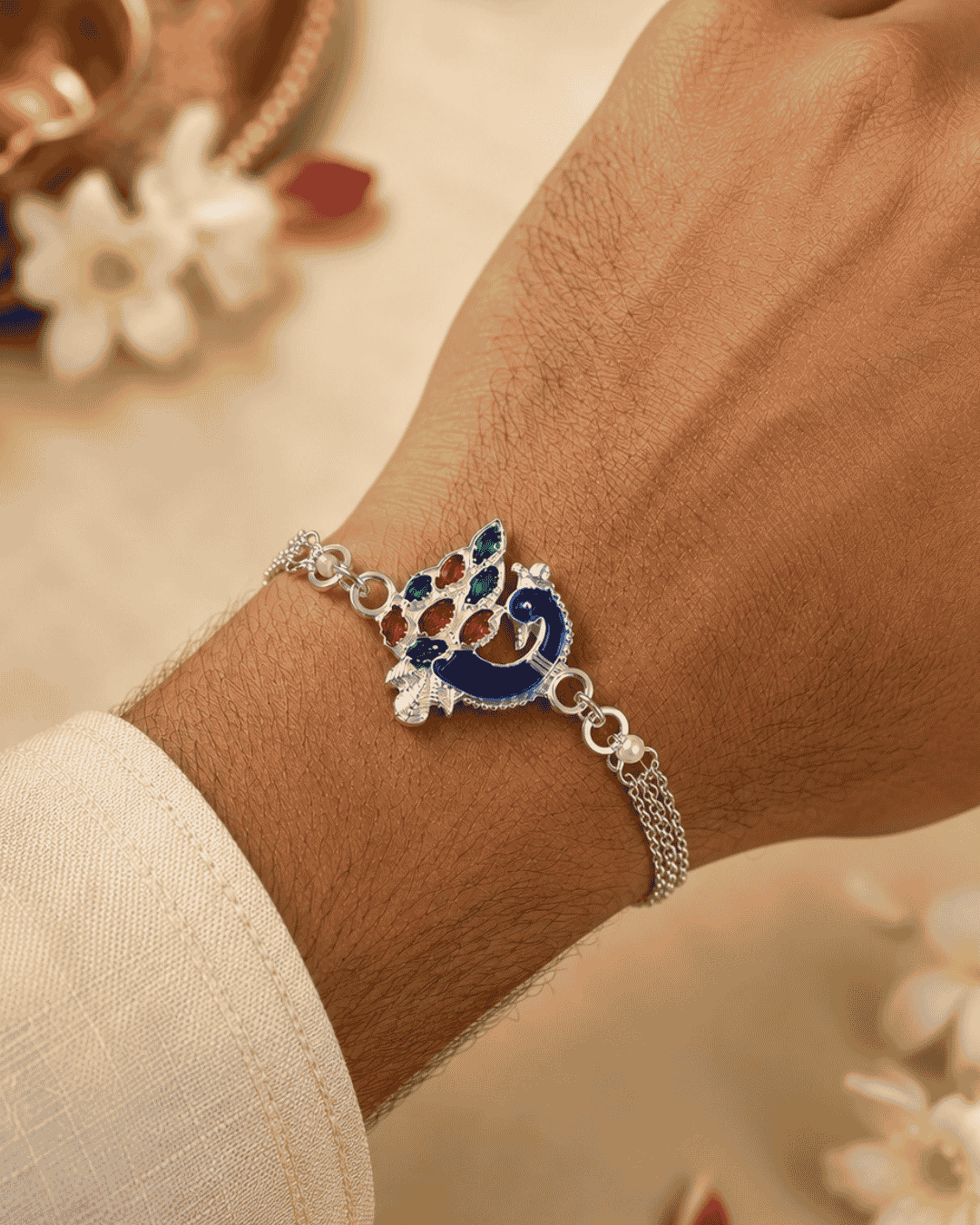 Beautiful Peacock silver plated Rakhi featuring a colorful enamel peacock design and bracelet-style chain. Perfect for Raksha Bandhan celebrations and thoughtful gifting.